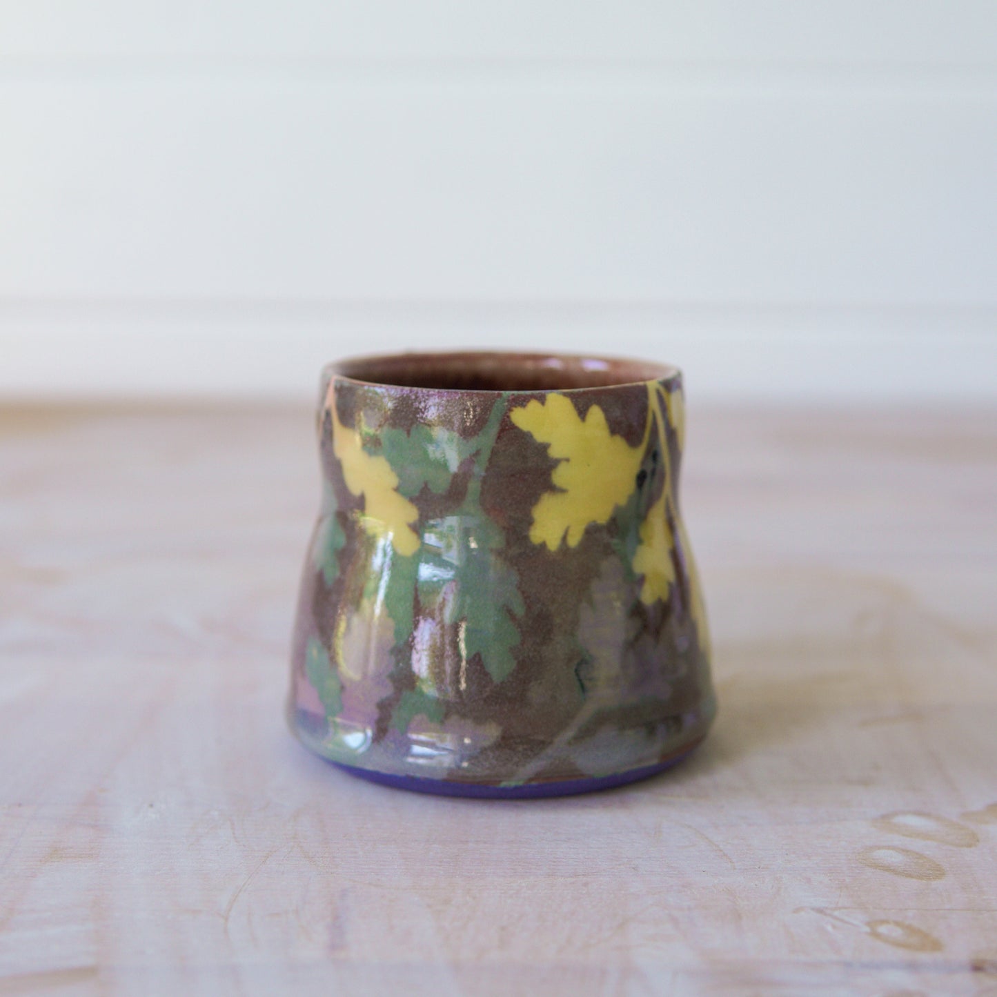 Ceramic mug with floral patterns on a wooden surface