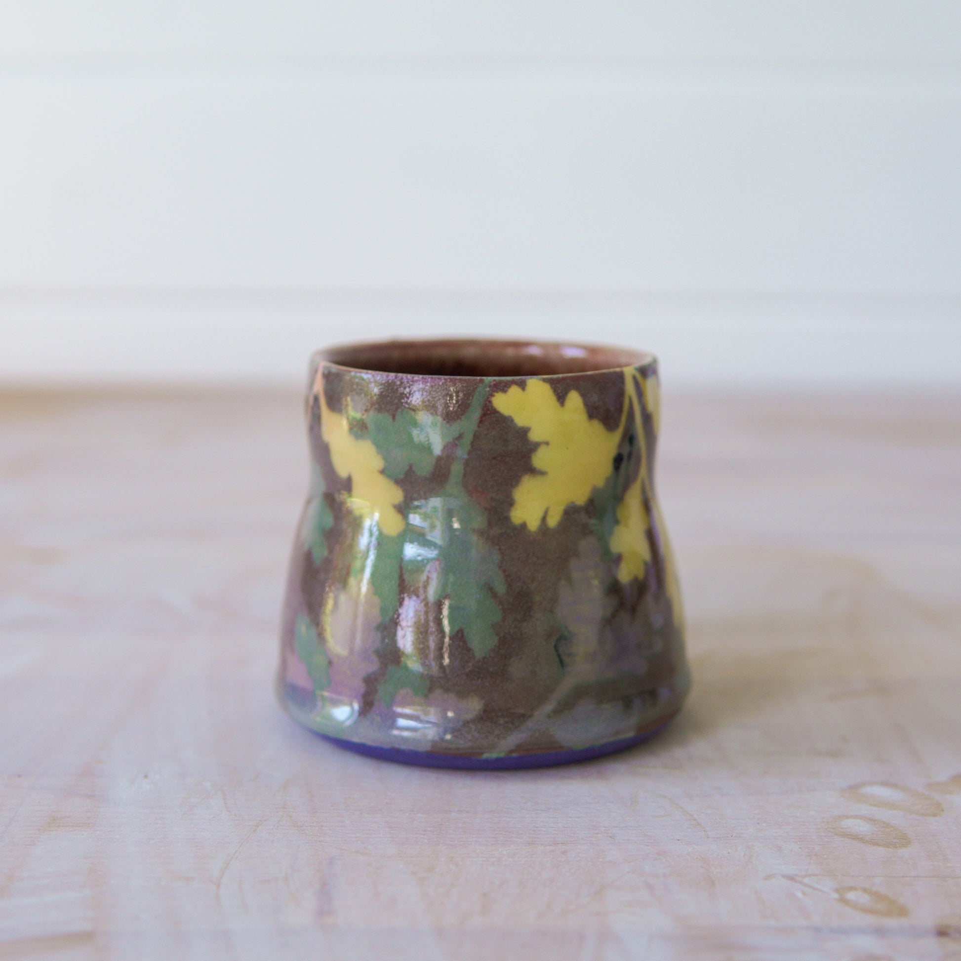Ceramic mug with floral patterns on a wooden surface