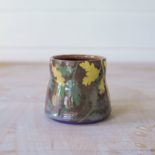 Ceramic mug with floral patterns on a wooden surface
